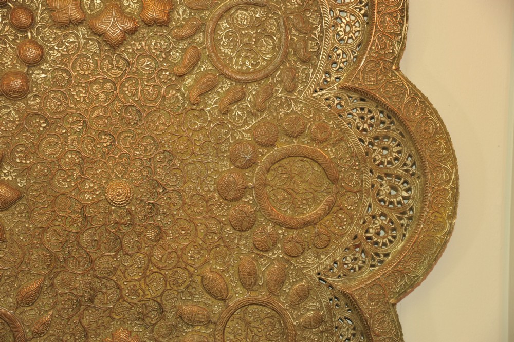 An antique Kashmiri lobed copper tray featuring detailed repousse floral work, pierced openwork sections, and residual silver plating. View VIII