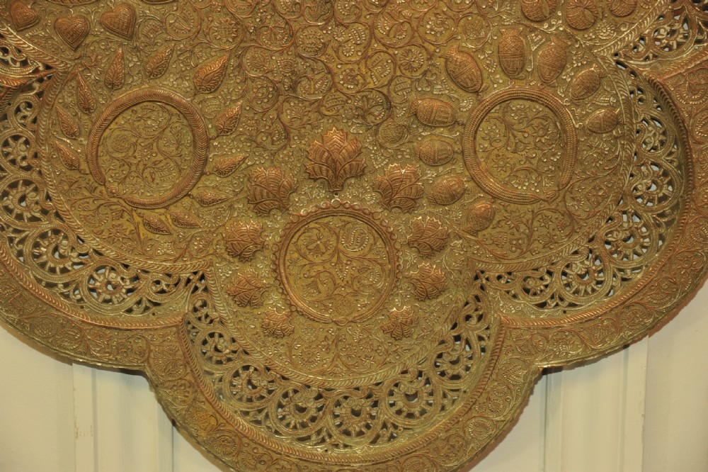 An antique Kashmiri lobed copper tray featuring detailed repousse floral work, pierced openwork sections, and residual silver plating. View XI