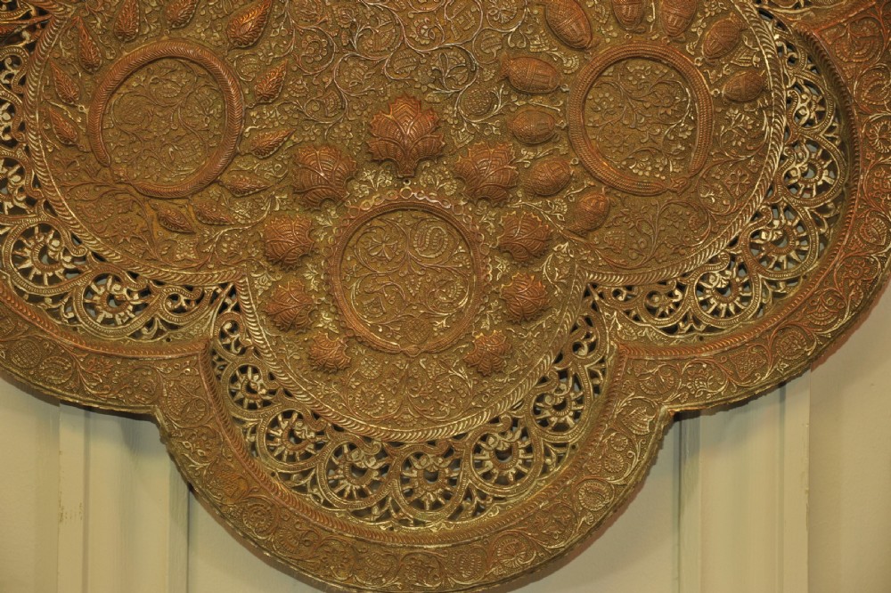 An antique Kashmiri lobed copper tray featuring detailed repousse floral work, pierced openwork sections, and residual silver plating. View XII