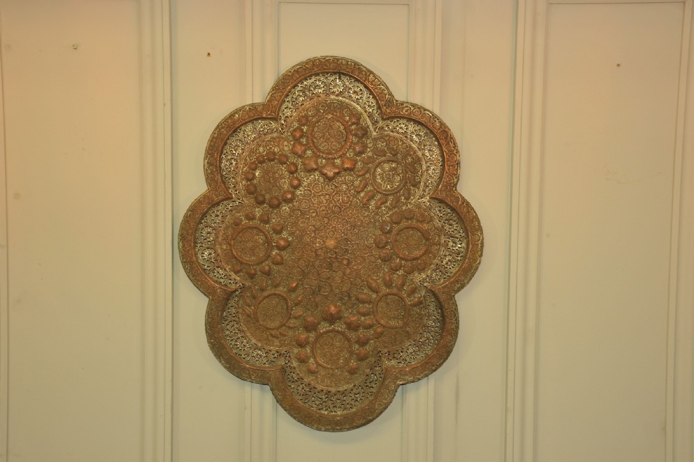 An antique Kashmiri lobed copper tray featuring detailed repousse floral work, pierced openwork sections, and residual silver plating. View XIV