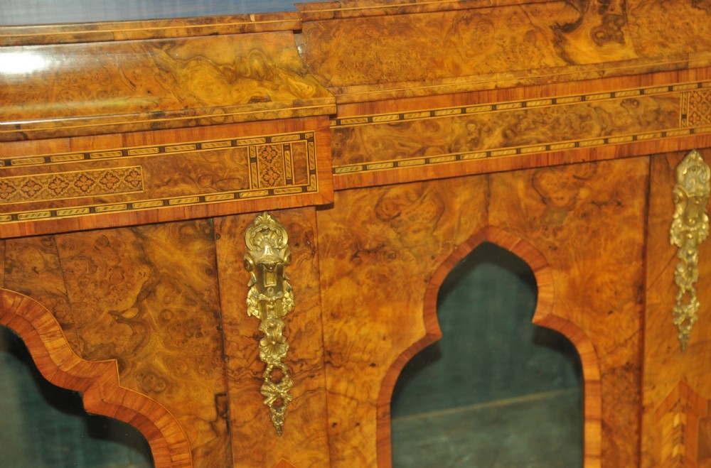 A Victorian burr walnut breakfront cabinet featuring four arched glazed doors, Tunbridgeware mosaic borders, and gilt bronze mounts. View III