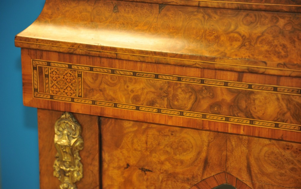 A Victorian burr walnut breakfront cabinet featuring four arched glazed doors, Tunbridgeware mosaic borders, and gilt bronze mounts. View IV