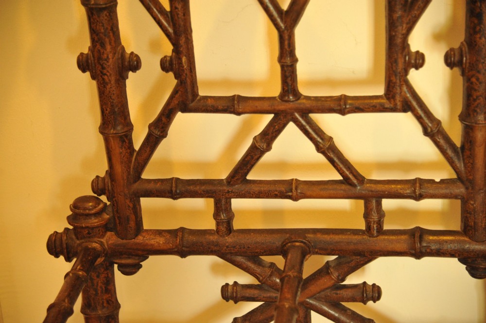 A late 19th-century French cast iron hall stand featuring a faux bamboo frame, central mirror, multiple hanging hooks, and an integrated umbrella rack with base drip trays. View III