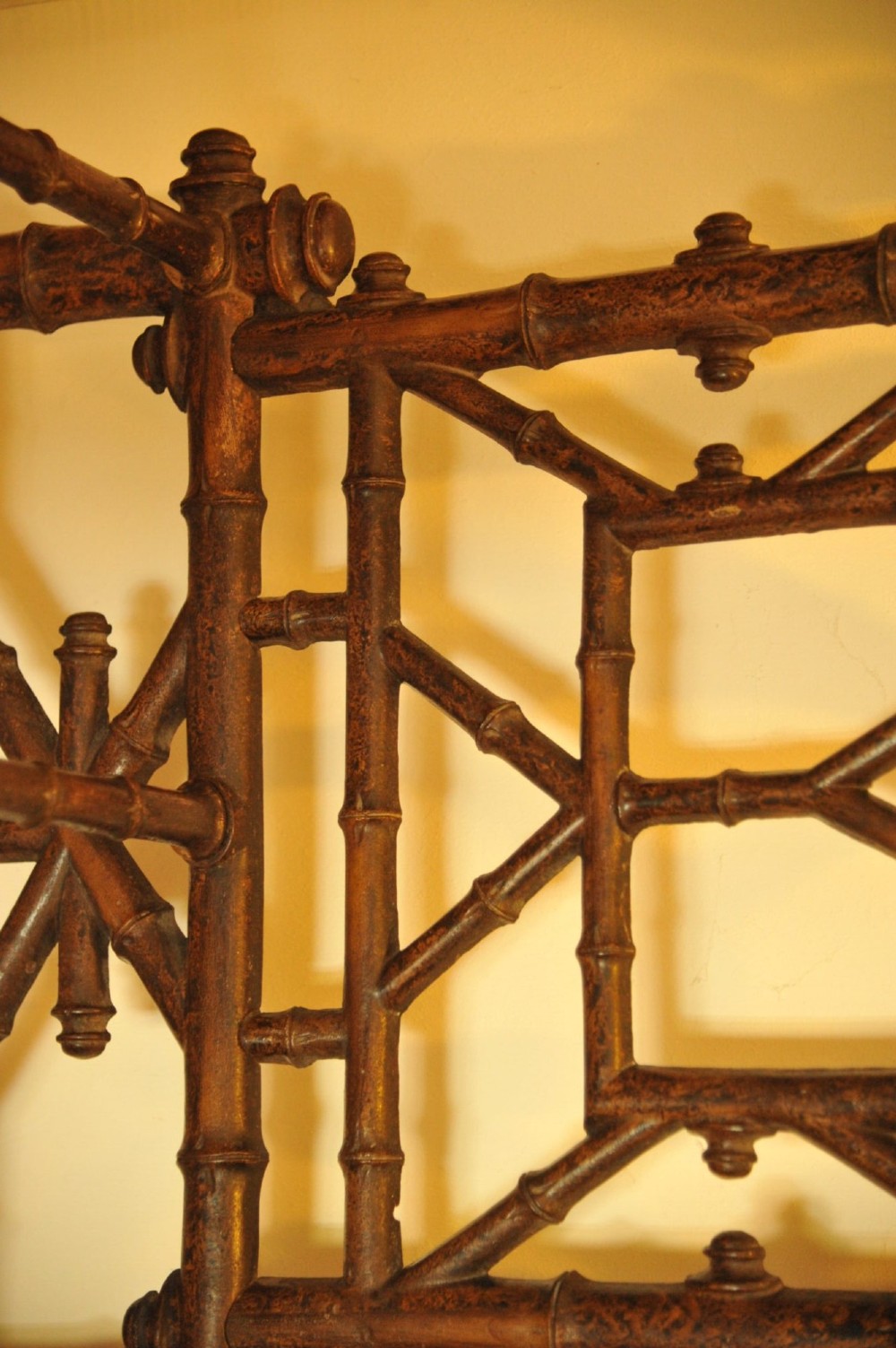 A late nineteenth-century French cast iron hall stand featuring a faux bamboo frame, central mirror, coat hooks, umbrella rail, and dual drip trays. View III