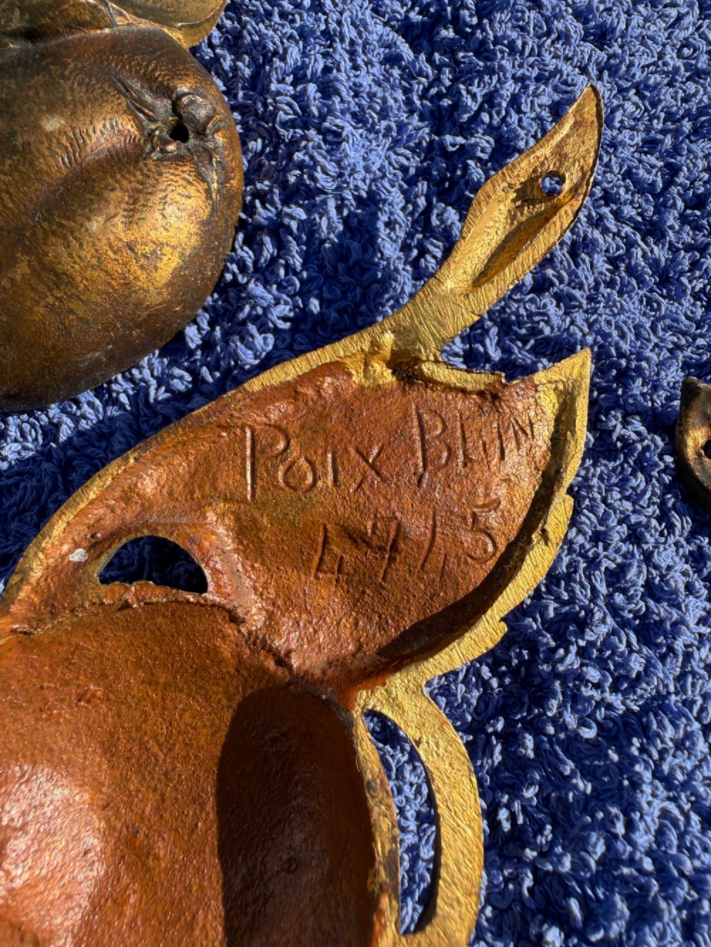 A close-up view of nineteenth-century gilt bronze appliques sculpted with apples, leaves, and branches in high relief. View II