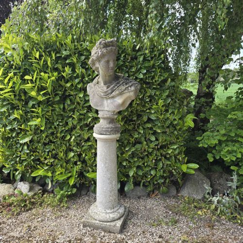 WELL WEATHERED BUST OF APOLLO ON PEDESTAL
