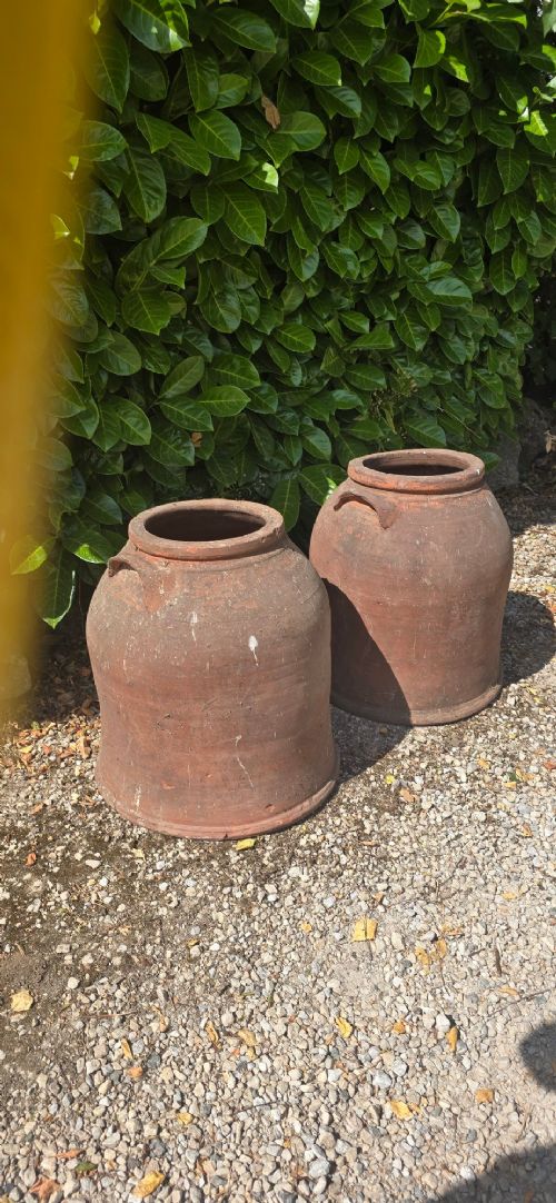 A pair of large Victorian terracotta rhubarb forcers with side handles and an aged clay surface. View IV