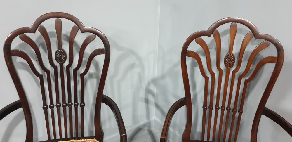 A pair of carved mahogany elbow chairs featuring openwork fan backs, swept armrests, terracotta striped upholstered seats, and cabriole front legs. View VI