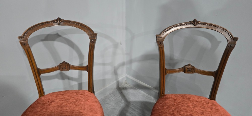 A pair of Victorian mahogany side chairs with openwork carved backs, turned front legs, and terracotta velvet seats. View IV