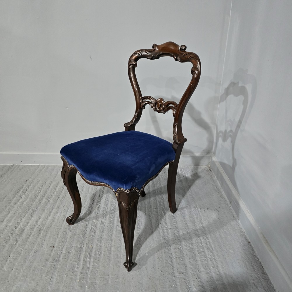 A Victorian rosewood side chair featuring an openwork balloon back, blue velvet upholstered seat, and cabriole legs. View II
