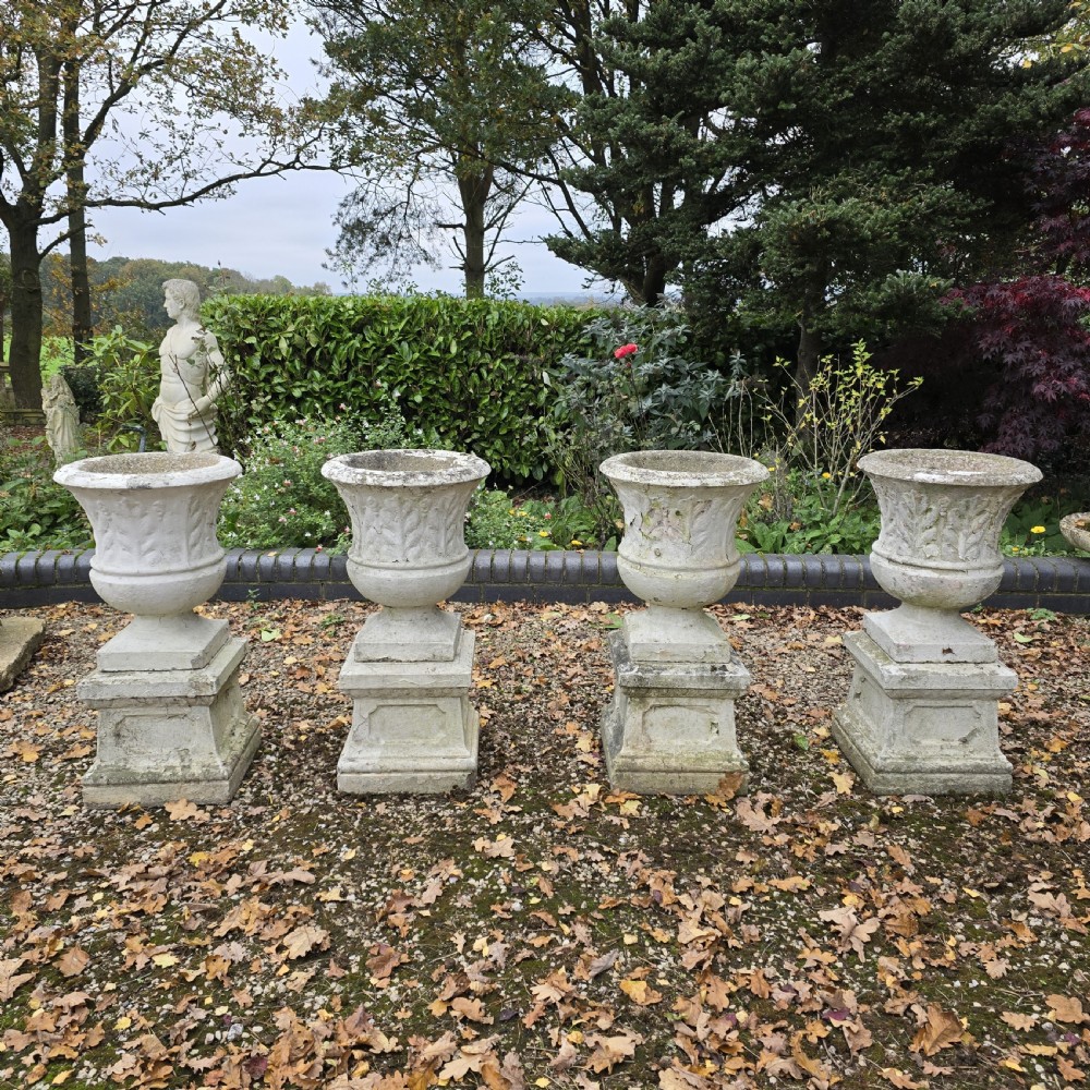Set Four Stone Urns on Plinths