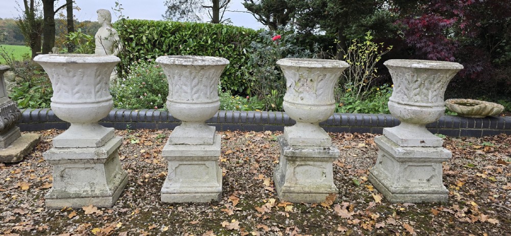 Set Four Stone Urns on Plinths View II