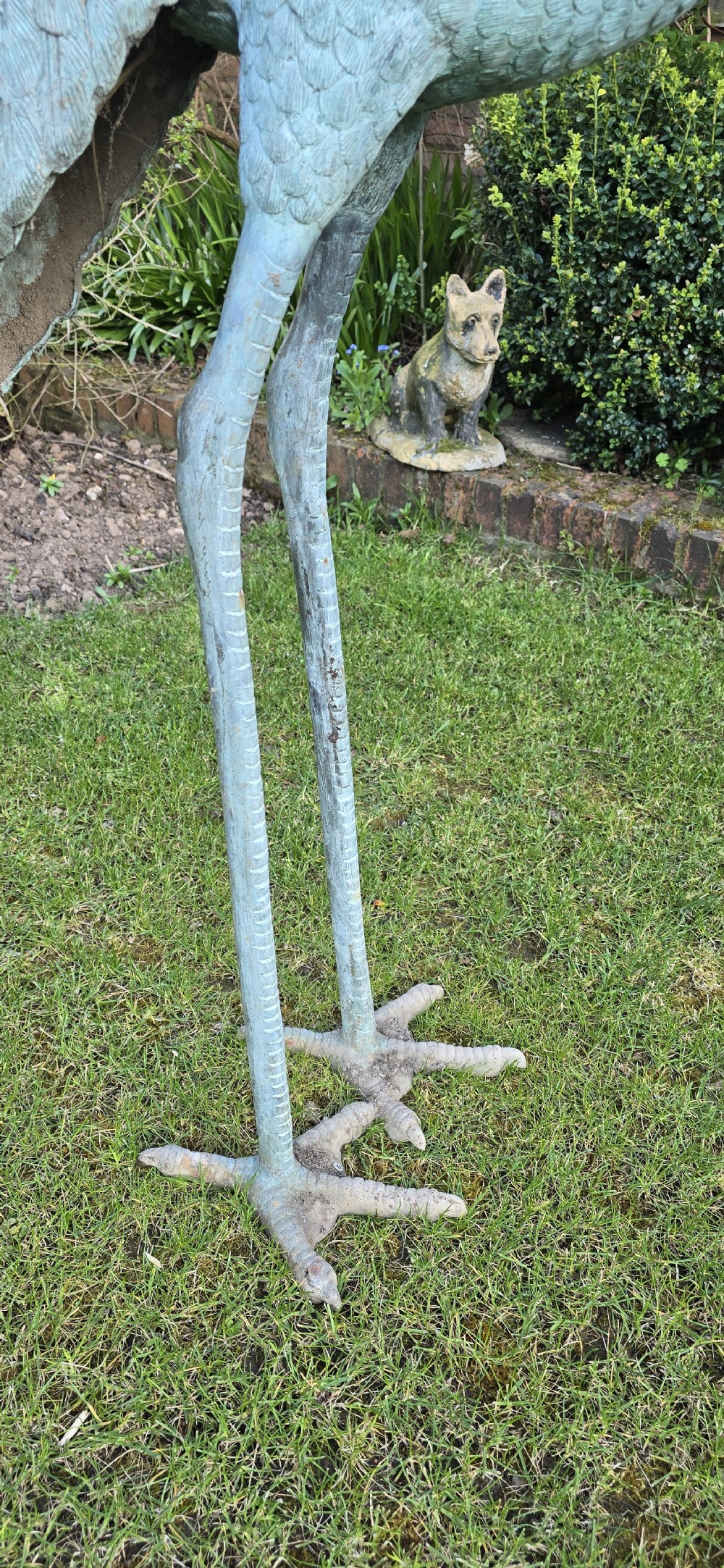 A pair of large cast metal crane statues featuring a weathered verdigris green finish and detailed feather texturing. View IX