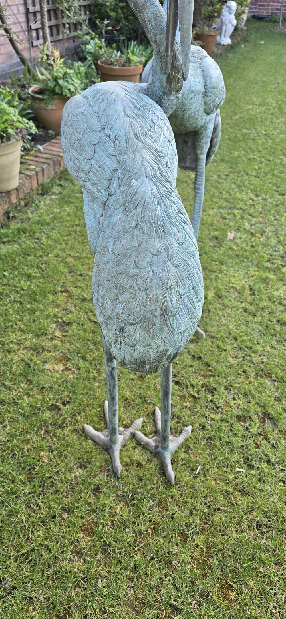 A pair of large cast metal crane statues featuring a weathered verdigris green finish and detailed feather texturing. View XIII