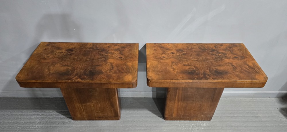 A pair of Art Deco console tables crafted from figured burr walnut, featuring overhanging rectangular tops with rounded edges set on thick rectangular pedestal bases. View II