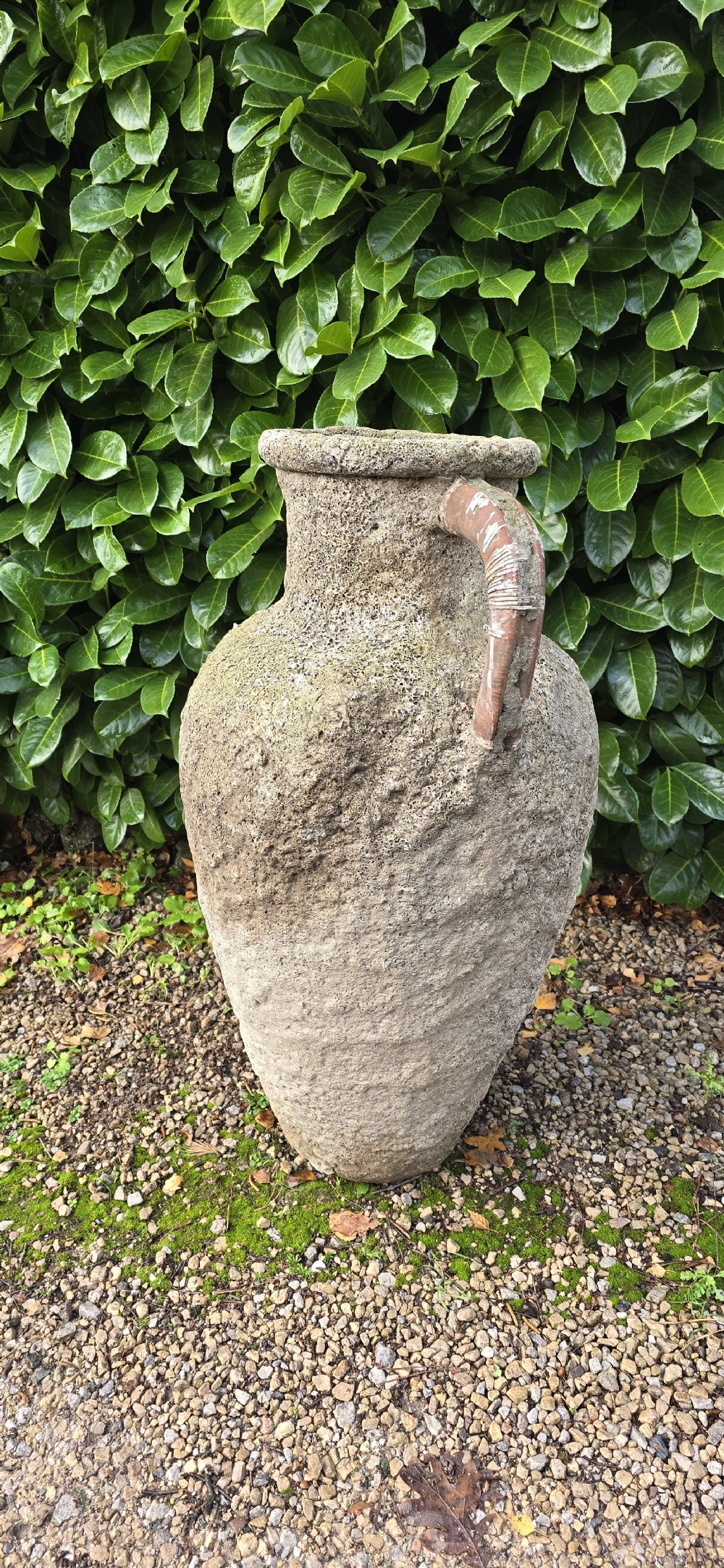 A large, heavily textured terracotta oil jar with a rounded body, narrow base, rolled rim, and twin loop handles. View IV