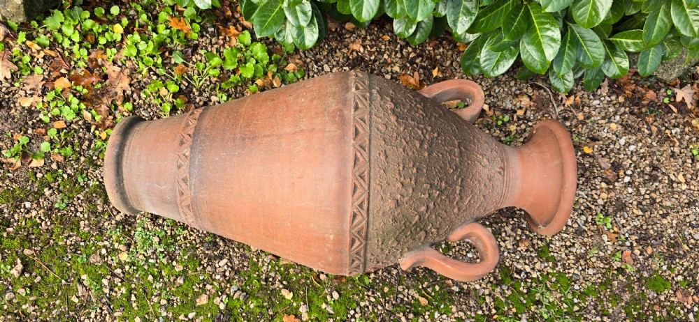 A large terracotta oil jar with two side handles, a textured upper body, and incised geometric patterning. View VII