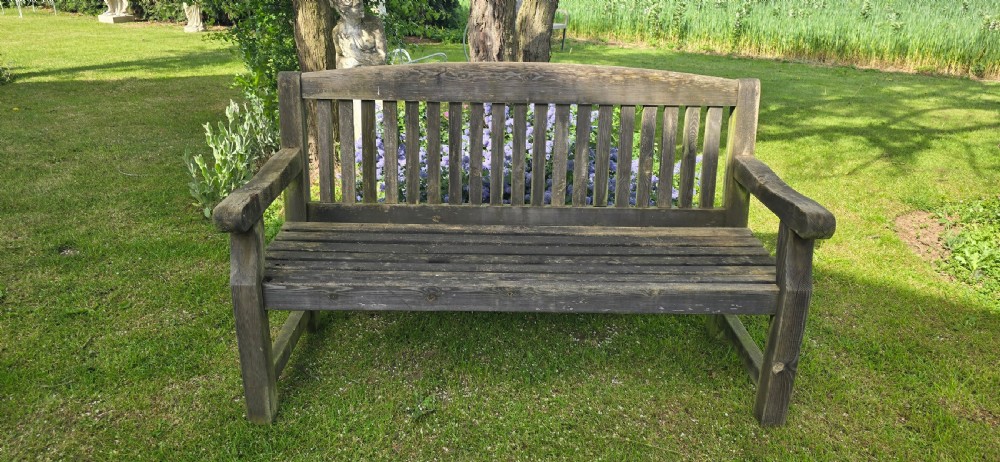 A weathered silver-grey teak garden bench featuring a slatted backrest, slatted seat, wide armrests, and straight post legs. View II