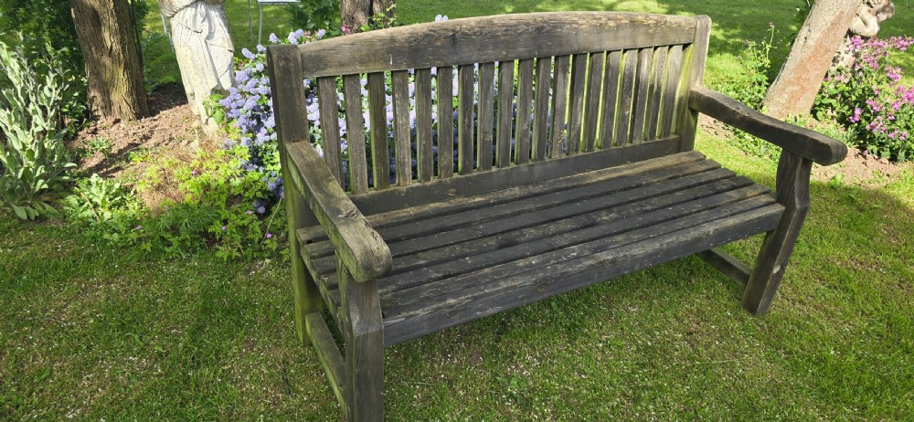 A weathered silver-grey teak garden bench featuring a slatted backrest, slatted seat, wide armrests, and straight post legs. View VIII