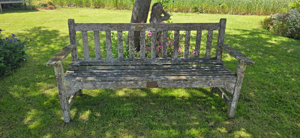 A rectangular slatted teak garden bench featuring a weathered grey oxidised finish, flat armrests, and square legs. View III