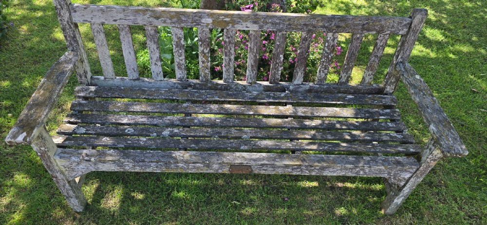 A rectangular slatted teak garden bench featuring a weathered grey oxidised finish, flat armrests, and square legs. View IV