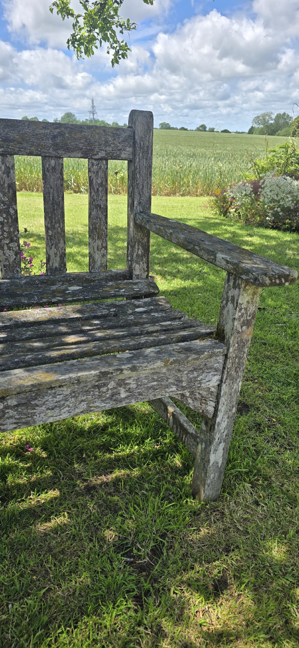 A rectangular slatted teak garden bench featuring a weathered grey oxidised finish, flat armrests, and square legs. View VI