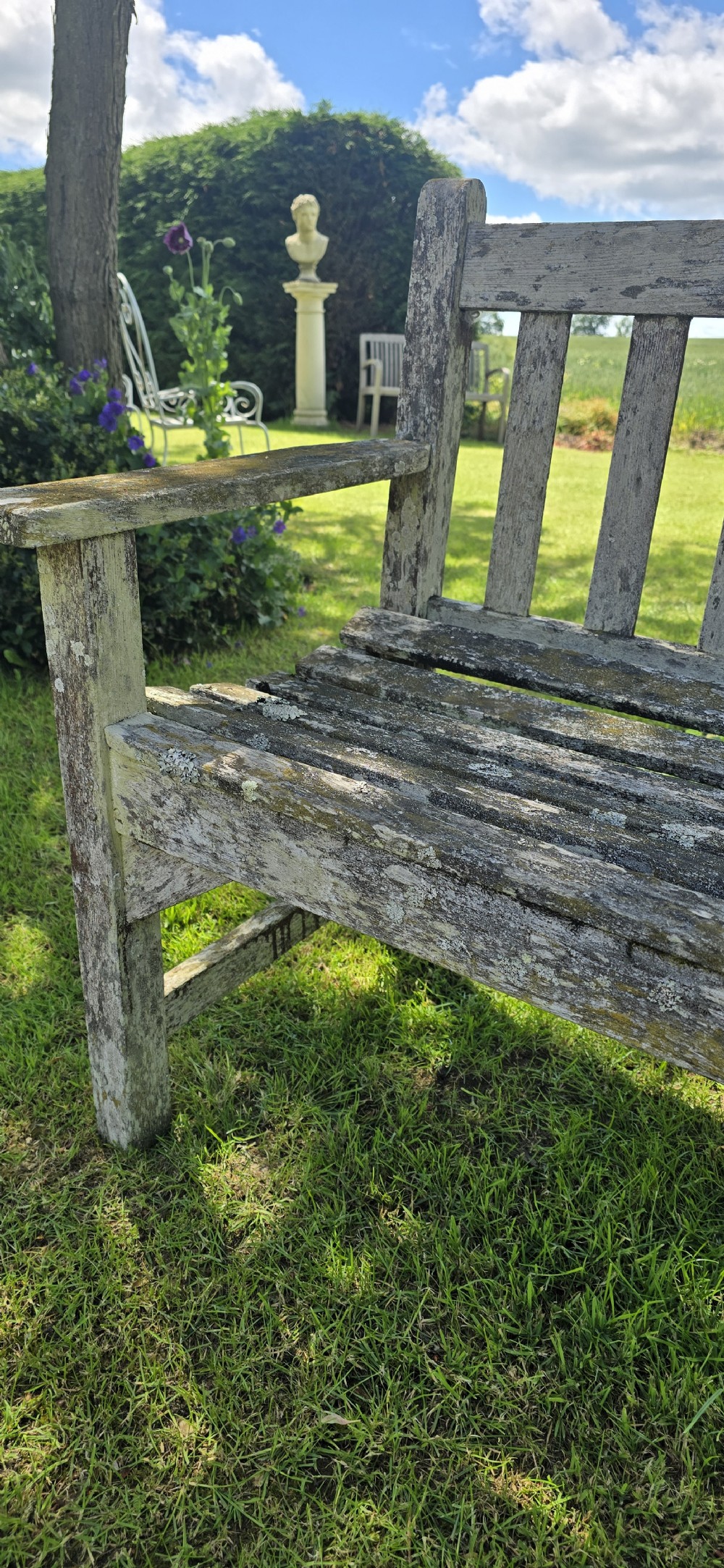 A rectangular slatted teak garden bench featuring a weathered grey oxidised finish, flat armrests, and square legs. View VII