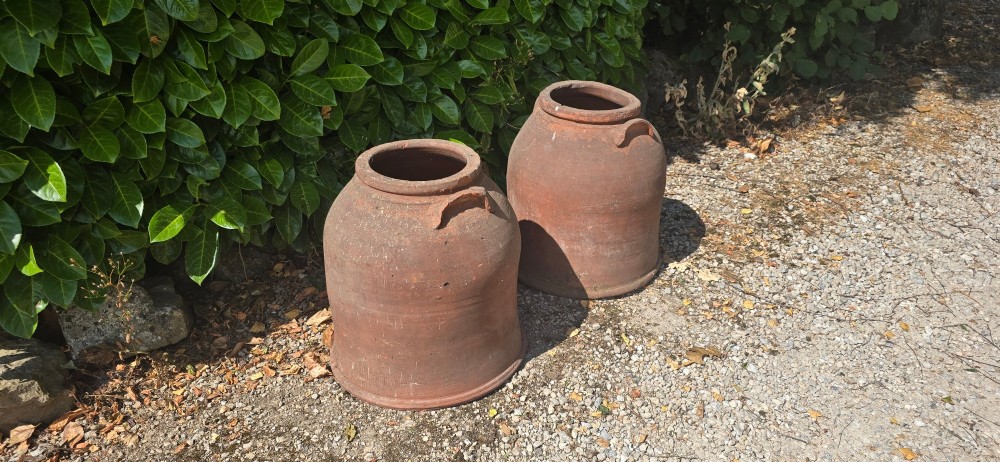 A pair of large Victorian terracotta rhubarb forcers with side handles and an aged clay surface. View II