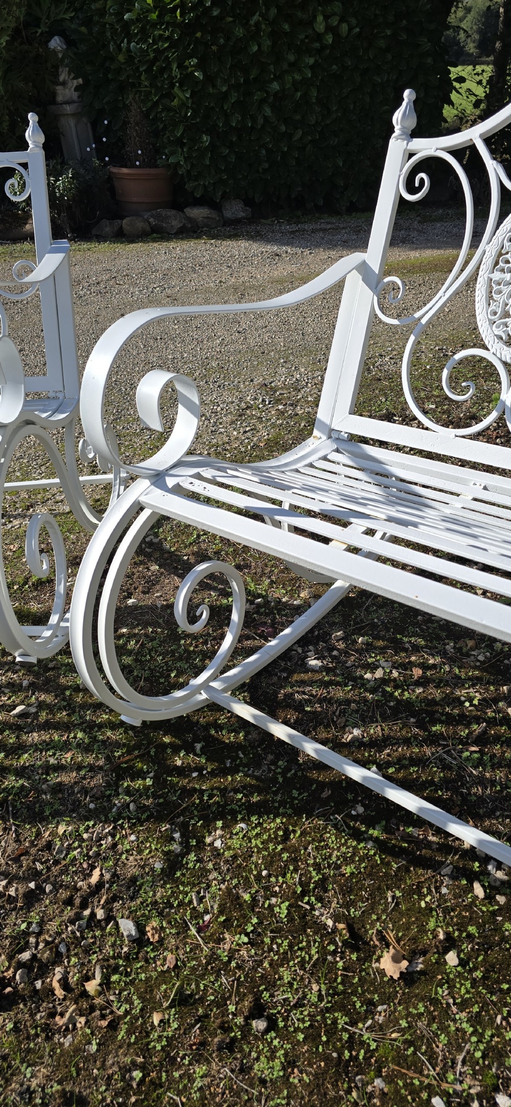 A pair of restored white-painted wrought iron garden rocking benches featuring ornate decorative scrollwork backrests and slatted seats. View VIII
