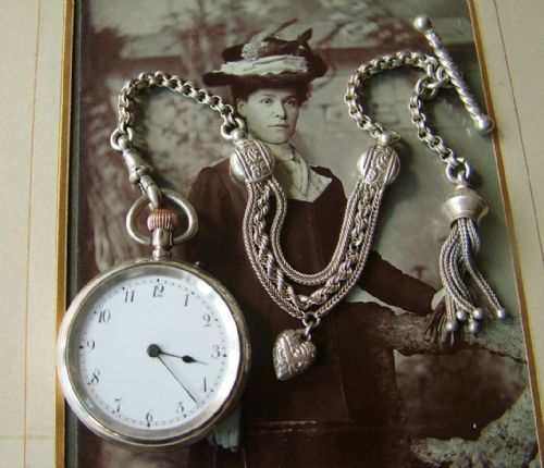 fig 1. A lady’s silver fob watch and albertina