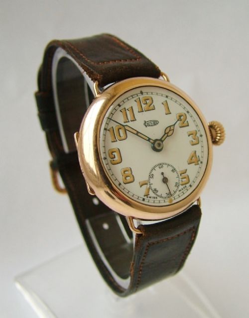 fig 1. A 9 carat gold Imshi trench watch
