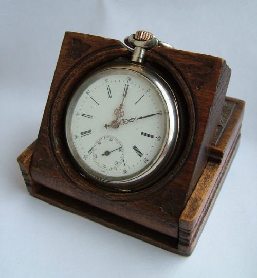 An Antique Pocket Watch in Stand by Chopard