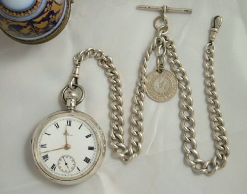 An Antique Silver Waltham Pocket Watch and Chain