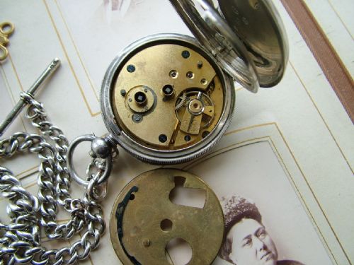 fig 1. An antique silver pocket watch and chain