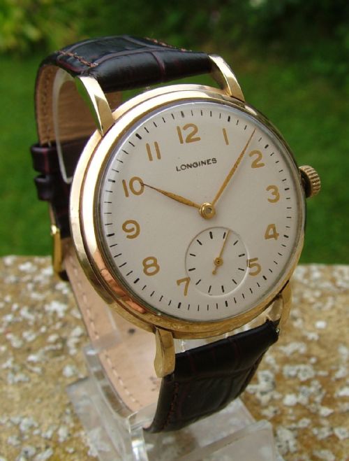 fig 1. A 9ct gold gents Longines wrist watch, 1950