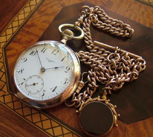 An Antique Omega Pocket Watch, Chain and Fob
