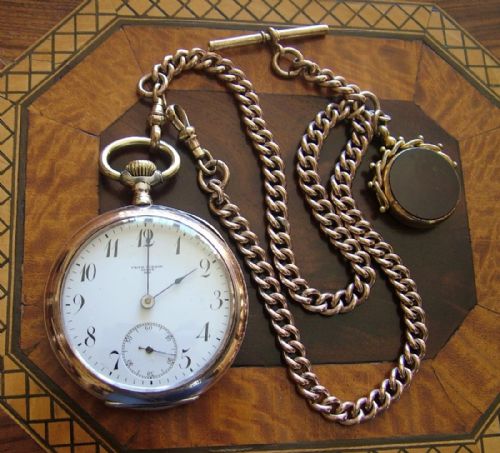 fig 1. An antique Omega pocket watch, chain and fob