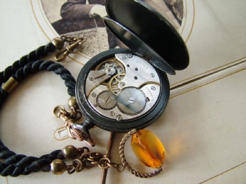 fig 2. 1920s Omega gun metal pocket watch with albert