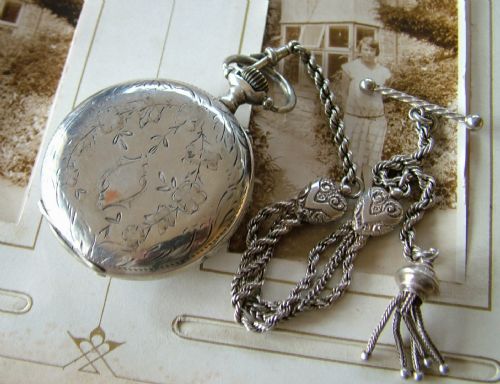fig 1. An antique open faced pocket watch and albertina