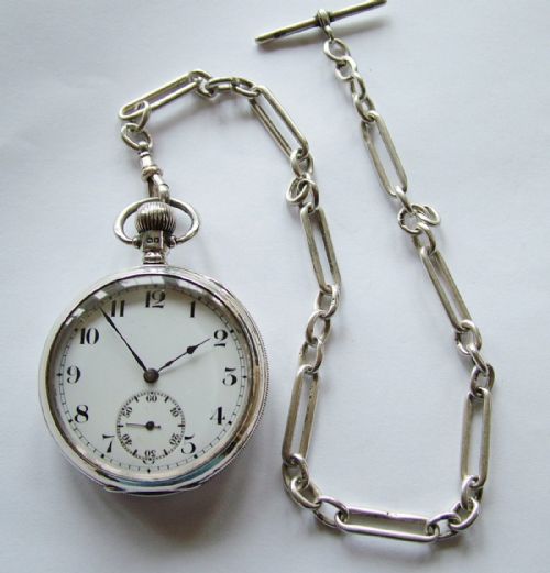fig 1. A Swiss open faced silver pocket watch with chain