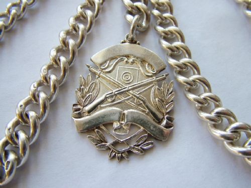 fig 1. Antique silver watch chain with rifle shooting fob