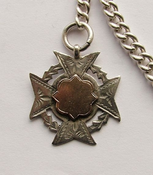 fig 1. An antique silver single pocket watch chain and fob.