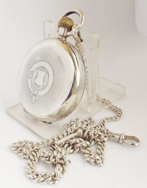 fig 1. An antique silver Omega pocket watch and chain.