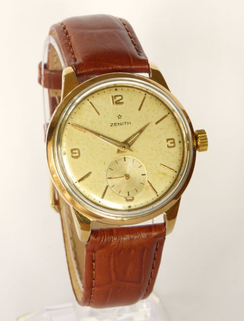 fig 1. A vintage 1960s Zenith Stellina mechanical wristwatch featuring a gold-plated case, champagne sub-seconds dial, and a brown crocodile-grain leather strap.