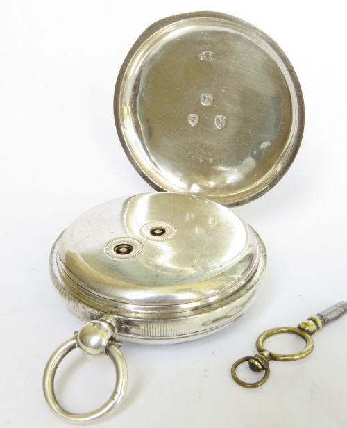 fig 2. An open-face silver pocket watch with a white enamel dial, black Roman numerals, blued steel hands, and a separate winding key.