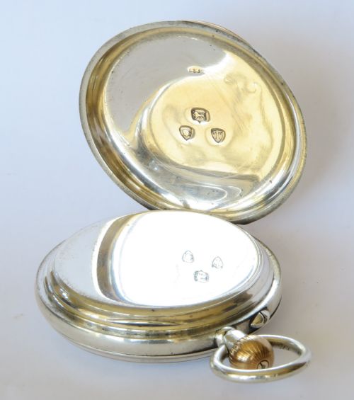 fig 2. A late Victorian sterling silver half hunter pocket watch featuring dark blue enamel Roman numerals on the outer cover and a central glass window.