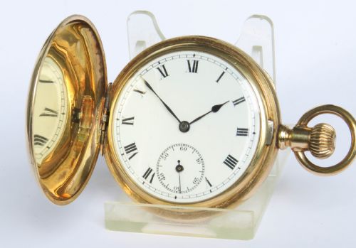 fig 1. An open antique gold full hunter pocket watch with a white enamel dial, black Roman numerals, and a subsidiary seconds sub-dial.