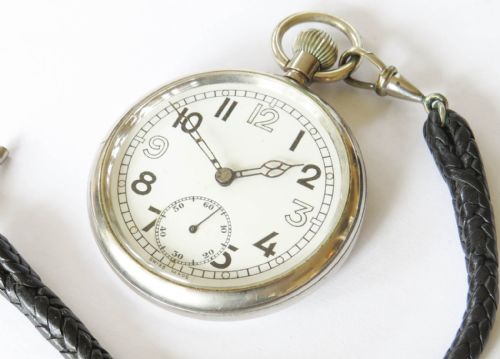 fig 1. A 1940s GSTP British military open-face pocket watch featuring a white dial, black Arabic numerals, a sub-seconds dial, and a black braided leather watch fob with a T-bar.