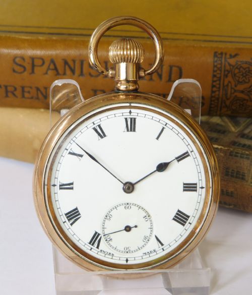 fig 1. A 1920s Swiss open-face pocket watch featuring a gold-toned case, a white dial with black Roman numerals, and a subsidiary seconds dial at the six oclock position.