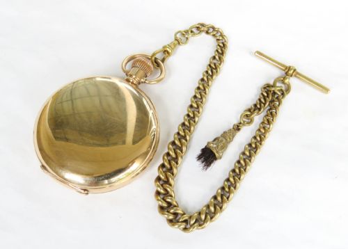 fig 3. An antique 1920s gold-plated open-face pocket watch by Syren featuring a white enamel dial with Roman numerals, a sub-seconds dial, and an attached curb link chain with a tassel fob.
